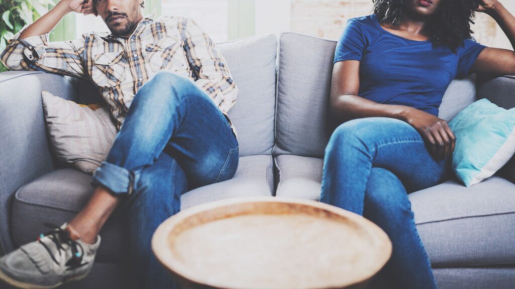 Couple sitting on sofa not speaking