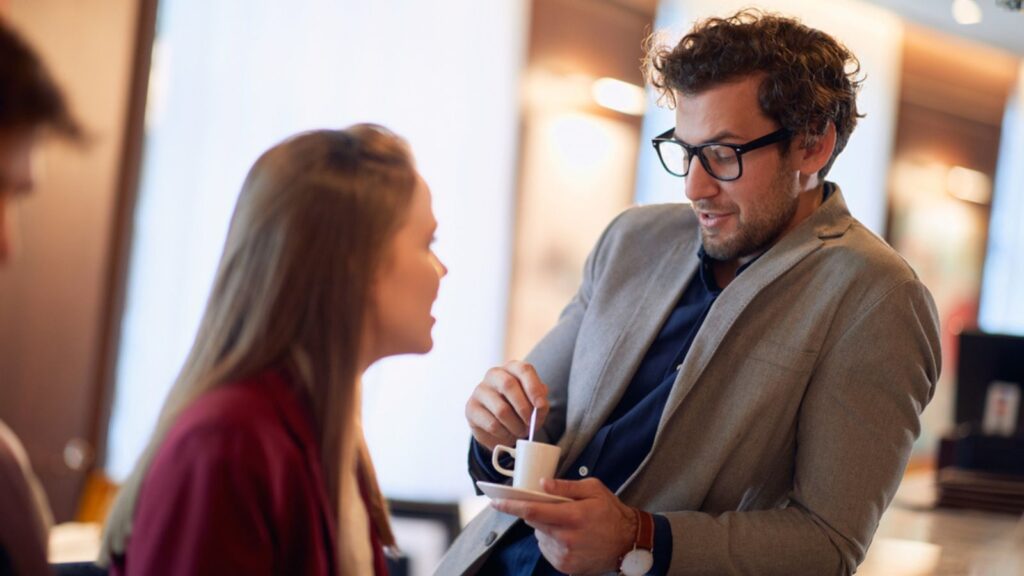 Two young people flirting at a coffee shop